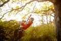 Happy child playing tire swing hanging at playground . Kids play on school or kindergarten yard. Active kid swing Royalty Free Stock Photo