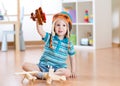 Happy child playing with toy airplane at home Royalty Free Stock Photo