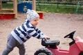 Happy child playing toy car outdoors in playground Royalty Free Stock Photo