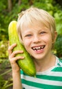 Happy child playing in vegetable garden