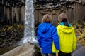 Happy child, posing in front of beautiful waterfall Svartifoss in Skaftafell national park Royalty Free Stock Photo