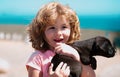 Happy child with puppy dog. Portrait kids boy with pet playing outside. Carefree childhood. Royalty Free Stock Photo