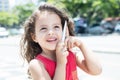 Happy child in a red shirt talking at phone Royalty Free Stock Photo