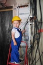 Happy child repairing electric panel at home during renovation. Royalty Free Stock Photo