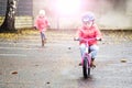 Happy child riding a bicycle in the fall. Cute little girl in safety helmet riding a bike outdoors. Little girl on a red bicycle. Royalty Free Stock Photo