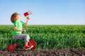 Child shouting through loudspeaker against blue summer sky Royalty Free Stock Photo