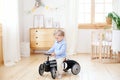 Happy child riding toy vintage car. Funny kid playing at home. Summer vacation and travel concept. Active little boy driving a car Royalty Free Stock Photo