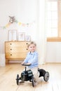 Happy child riding toy vintage car. Funny kid playing at home. Summer vacation and travel concept. Active little boy driving a car Royalty Free Stock Photo