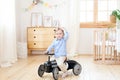 Happy child riding toy vintage car. Funny kid playing at home. Summer vacation and travel concept. Active little boy driving a car Royalty Free Stock Photo