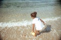 Adorable little girl splashing in tropical shallow water during summer vacation Royalty Free Stock Photo