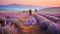 Happy child walking in lavender field at sunset Royalty Free Stock Photo