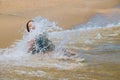 Happy child running in the waves during summer vacation on beach on ocean coast Little girl learning to swim Royalty Free Stock Photo