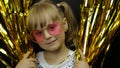 Happy child in shiny foil fringe golden curtain. Little blonde girl Royalty Free Stock Photo