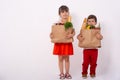 Happy child and shopping cart. Kids buying food at grocery store or supermarket. Children with vegetables, bread, milk and other p