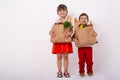 Happy child and shopping cart. Kids buying food at grocery store or supermarket. Children with vegetables, bread, milk and other p