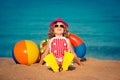 Happy child sitting on the beach