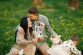 Pregnant mother and her little daughter and husband sitting on a grass in a park Royalty Free Stock Photo