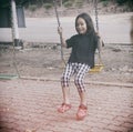 Happy child sitting swinging on swing at outdoor Royalty Free Stock Photo