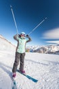 Happy child skier in mountains holds up ski poles. Ski lesson alpine school. Royalty Free Stock Photo