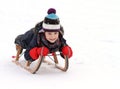 Happy child on sledge in winter