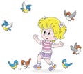 Little girl playing with merry small birds