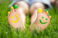 Happy child with smile on feet lying on green spring grass Royalty Free Stock Photo