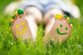 Happy child with smile on feet lying on green spring grass Royalty Free Stock Photo