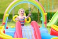 Happy child splashing in inflatable garden pool Royalty Free Stock Photo