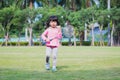 Happy child standing and holding badminton racket and shuttlecock ball. Sweet smile girl. Kindergarten kid playing sport