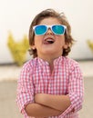 Happy child with sunglasses in the garden