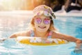 happy child in swimming pool with inflatable ring at resort hotel water park Royalty Free Stock Photo