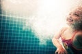 Happy child swimming underwater in swimming pool during diving training Royalty Free Stock Photo