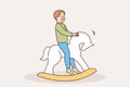 Happy child swinging on rocking horse Royalty Free Stock Photo