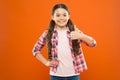 Happy child thumb up. childrens day. childhood happiness. little girl orange background. kid fashion. smiling school