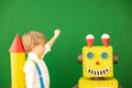 Happy child with toy robot in class Royalty Free Stock Photo