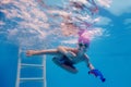 Happy child is trained to dive in the pool