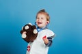 Happy child veterinarian smile with teddy bear on blue background