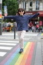 Happy child walking along the rainbow lines