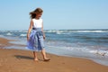 Happy child walks along the coastline ocean