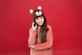 Happy child in warm winter clothes of knitted sweater and earflap hat ready for holiday activity, winter fashion