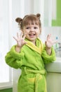 Happy child washing hands and showing soapy palms