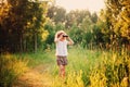 Happy child watching birds with binocular in summer forest