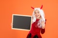 Happy child wear devil horns and white hair wig holding school chalkboard for halloween ad, happy halloween Royalty Free Stock Photo