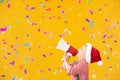 Happy child wearing Santa Claus costume speaking by megaphone Royalty Free Stock Photo