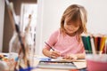 Happy child, writing and drawing with color for creativity, learning or education at home. Young girl with color pencil Royalty Free Stock Photo