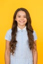 Happy child on yellow background with long hair. fashion and beauty. childhood happiness. healthy hair. small girl in Royalty Free Stock Photo