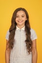 Happy child on yellow background with long hair. fashion and beauty. childhood happiness. healthy hair. small girl in Royalty Free Stock Photo