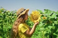 happy childhood. beautiful girl wear straw summer hat in field. pretty kid with flower. beauty of summer nature. little Royalty Free Stock Photo