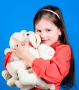 Happy childhood. Birthday. little girl playing game in playroom. toys for kid. small girl with soft bear toy. hugging a Royalty Free Stock Photo