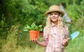 Happy childhood. Child in hat with shoulder blade small shovel hoe. Happy smiling gardener girl. Ranch girl. Planting Royalty Free Stock Photo